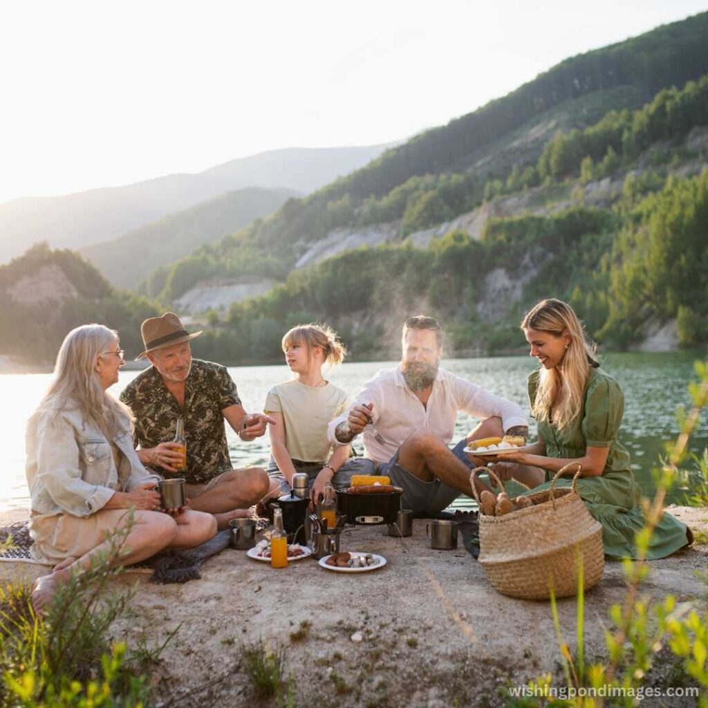A happy family barbecuing near the lake - Nature Images