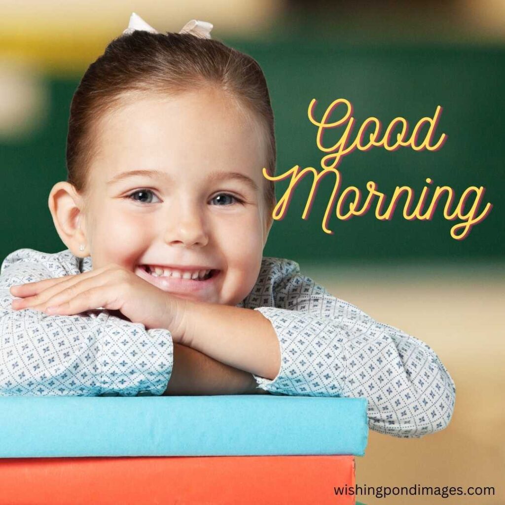 A little child waving good morning while smiling and tucking her arms inside a full-sleeved white shirt