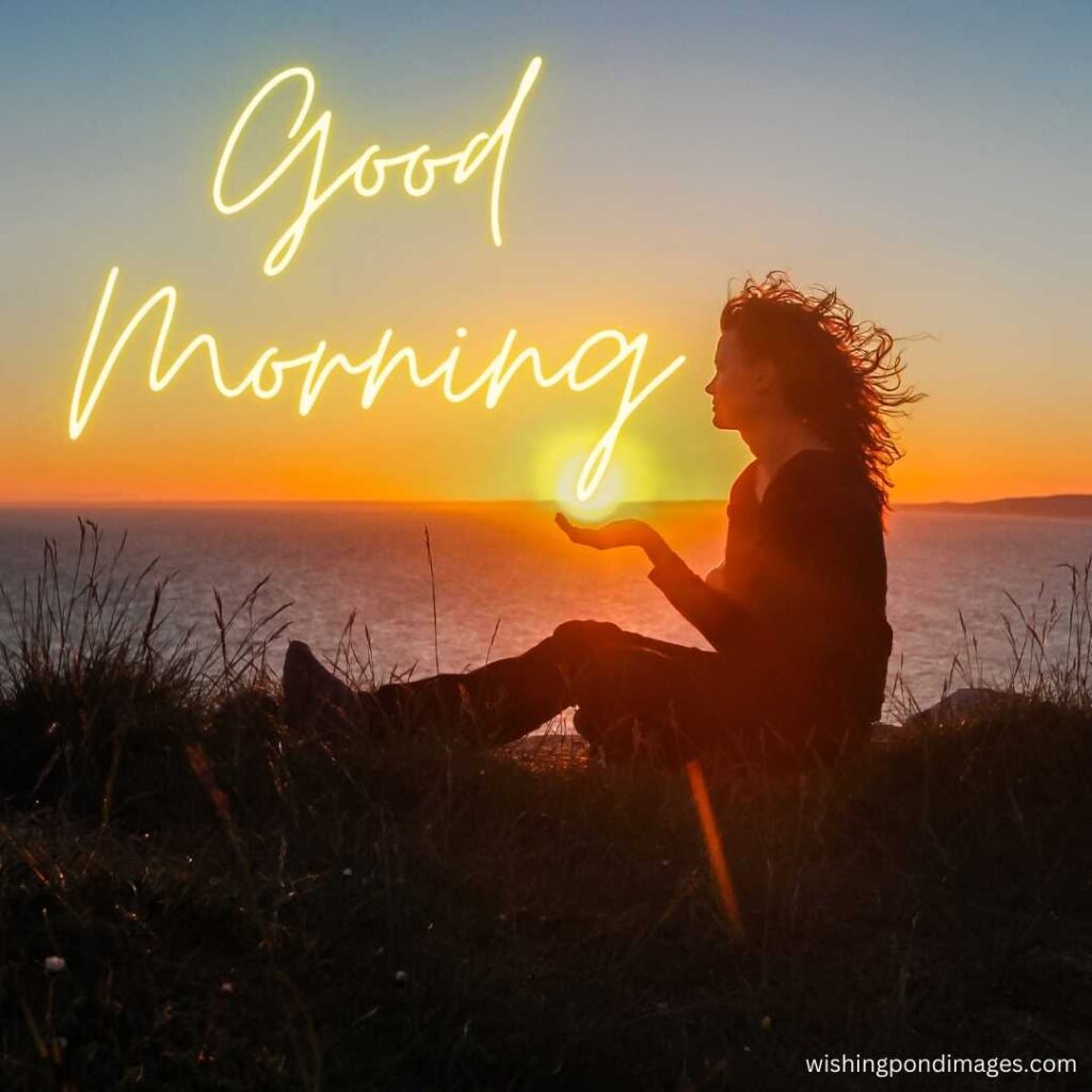 A young girl sitting near the beach watching the sun in the morning