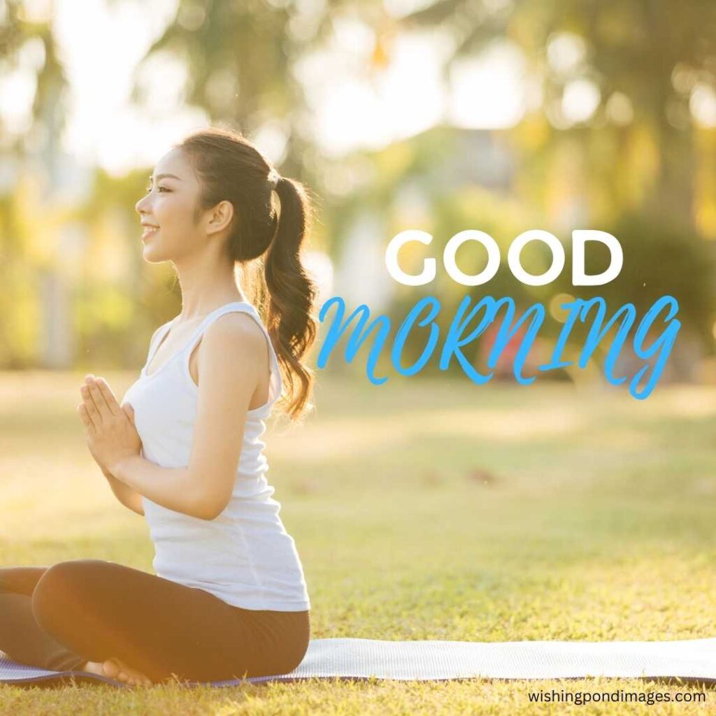 A young girl with a smiley face sitting in the meditating pose in the park in the morning