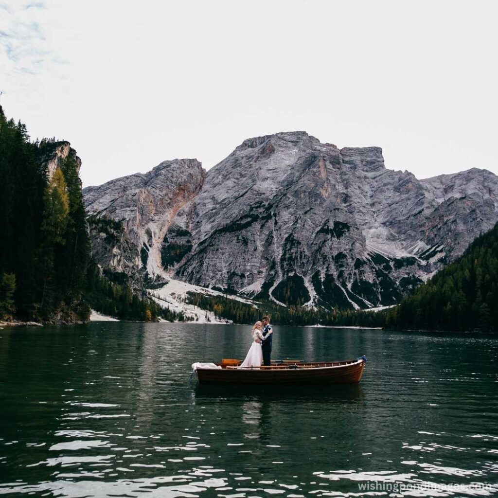 Beautiful couple in boat on mountain lake - Nature Images