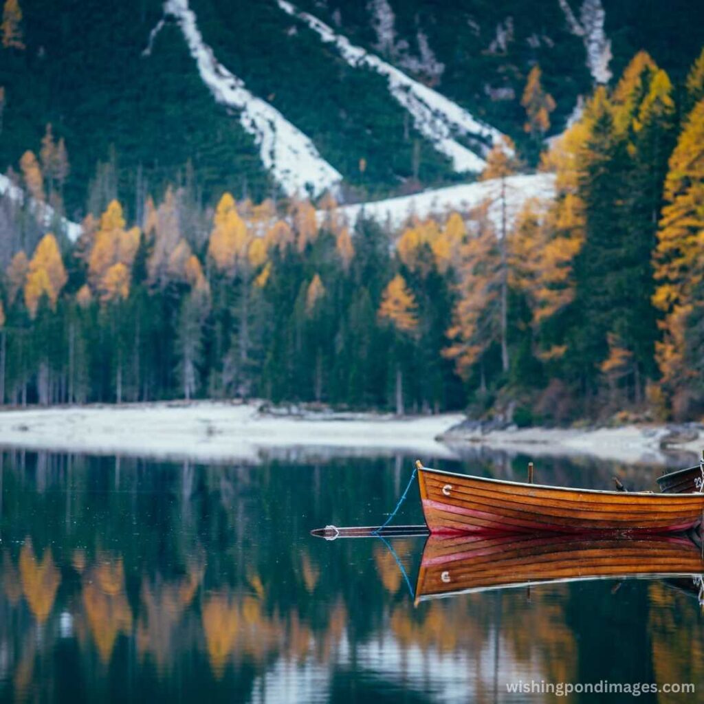 Brown boat near the mountain lake - Nature Images