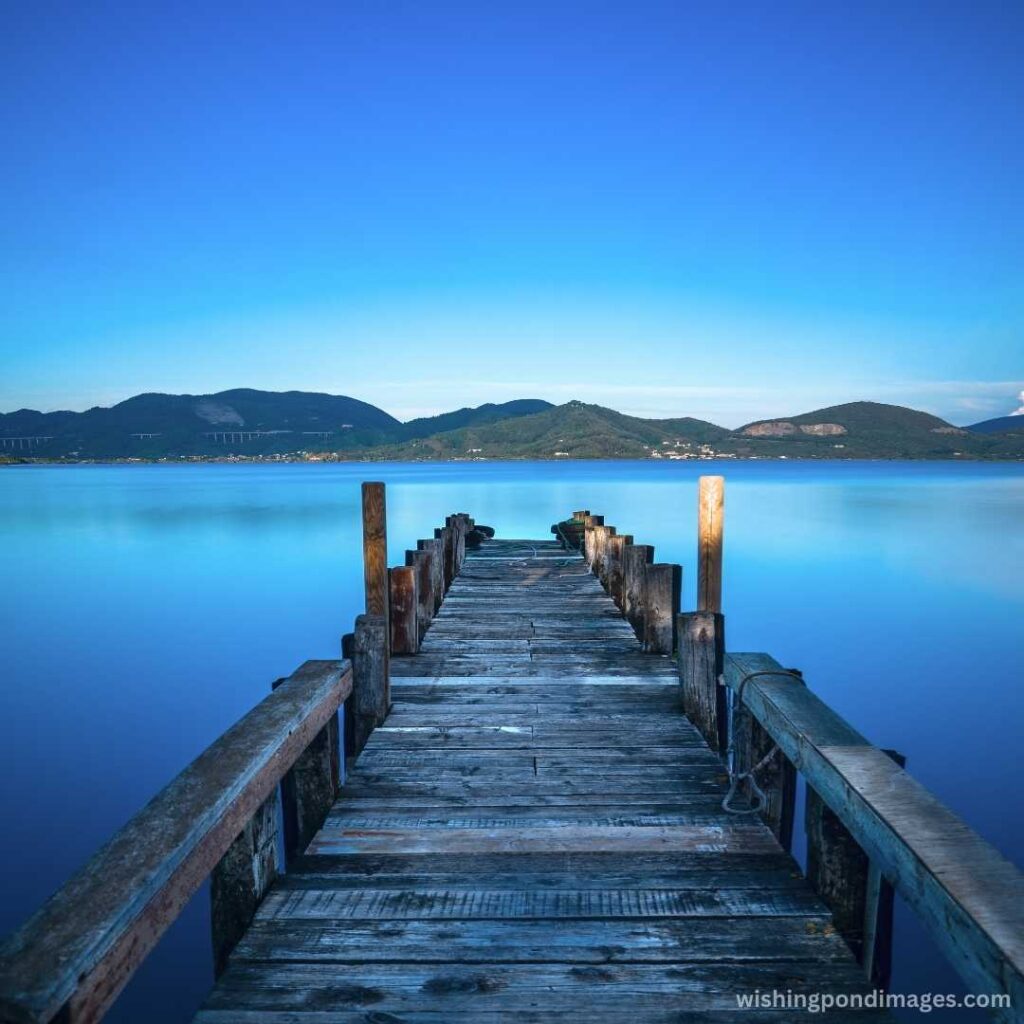 Wooden pier on a blue lake at sunset - Nature Images