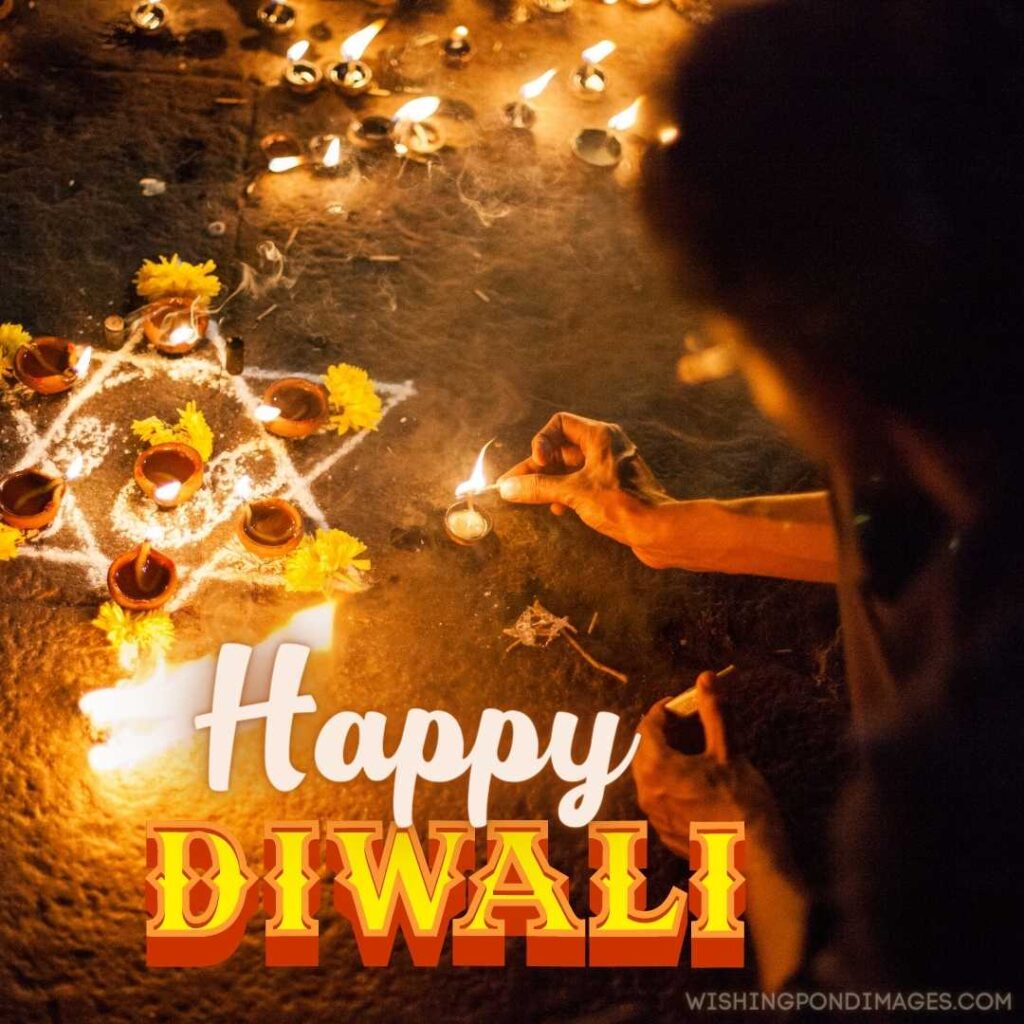 A young beautiful girl decorating outside home with fire lamp diyas - Happy Diwali Images