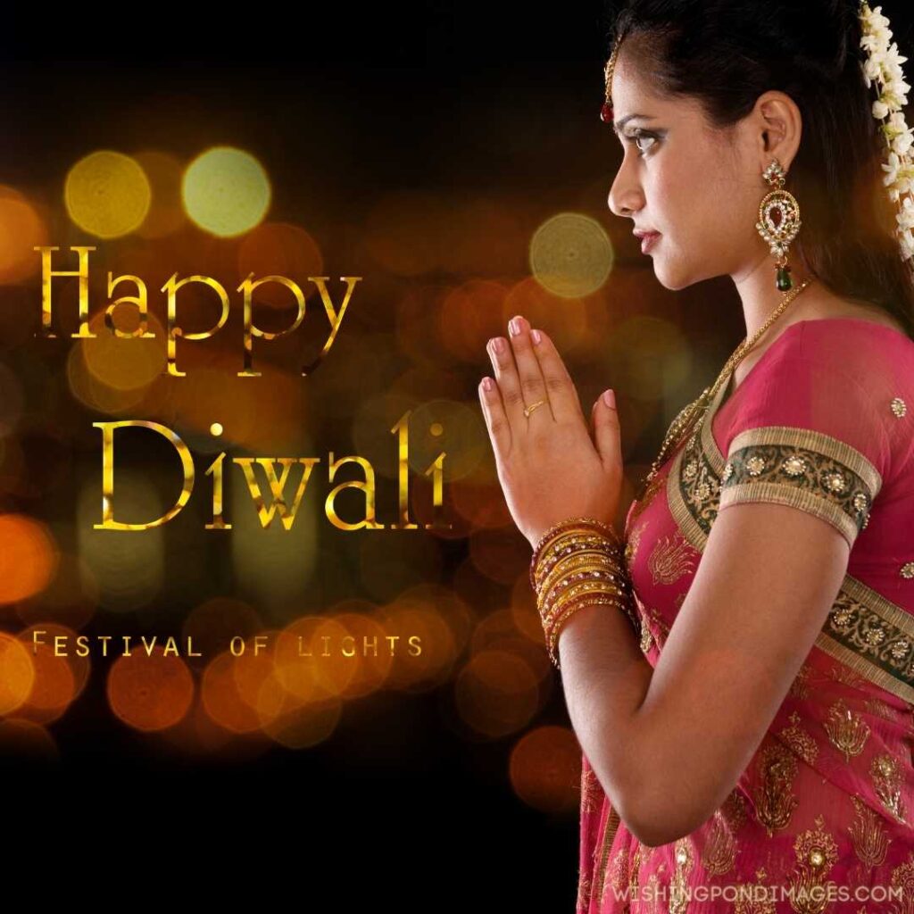 An Indian woman holding both hands wishing Happy Diwali - Happy Diwali Images