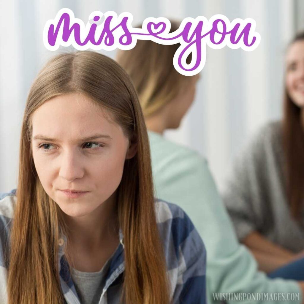 A sad young girl sitting with friends talking in the background