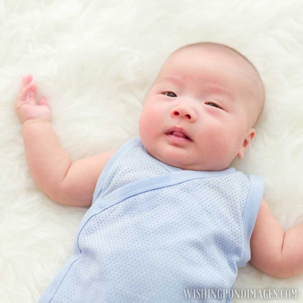 A cute little Asian newborn baby lying on bed at home. Newborn baby images