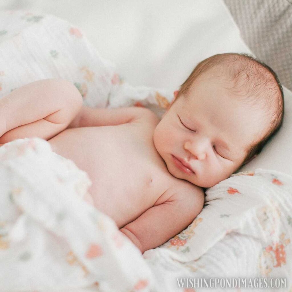 A cute little newborn baby sleeping in bed. Newborn baby images