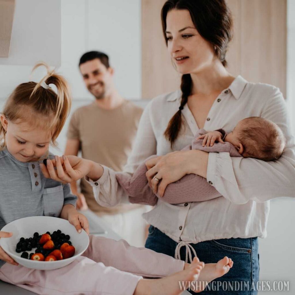 A happy young family with newborn baby and little girl enjoying time together at home. Newborn baby image