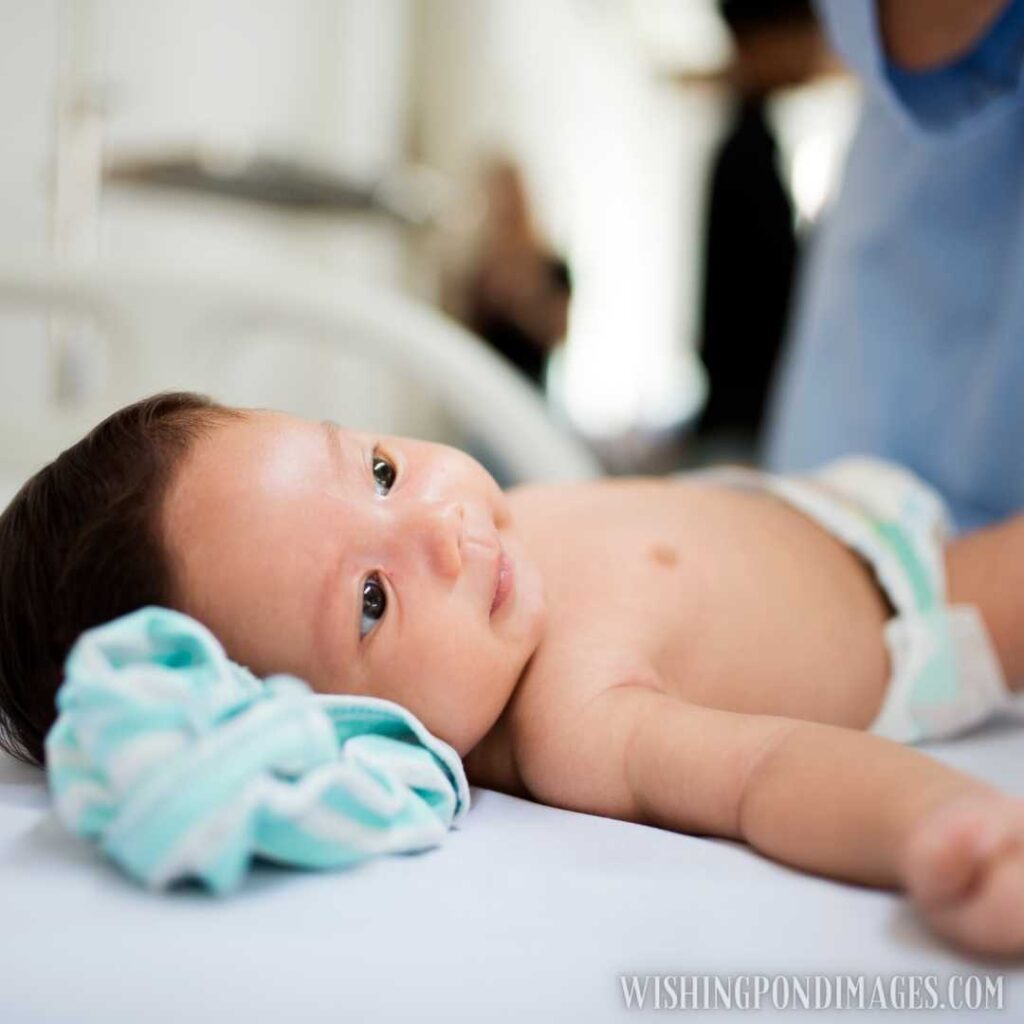 A newborn baby lying on bed with little smile on her face. Newborn baby image
