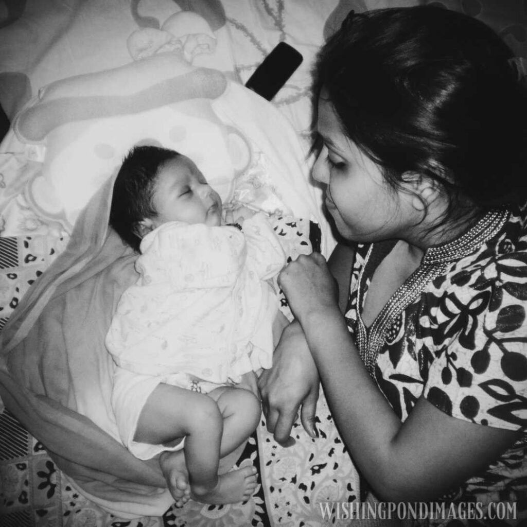 A young mother sitting besides her newborn baby. Newborn baby images