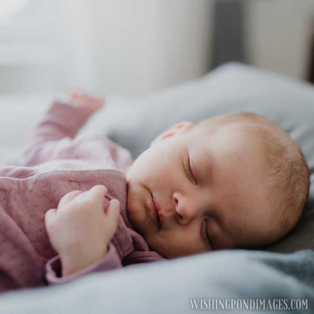 An image of newborn baby girl, sleeping and lying on sofa indoors at home. Newborn baby image