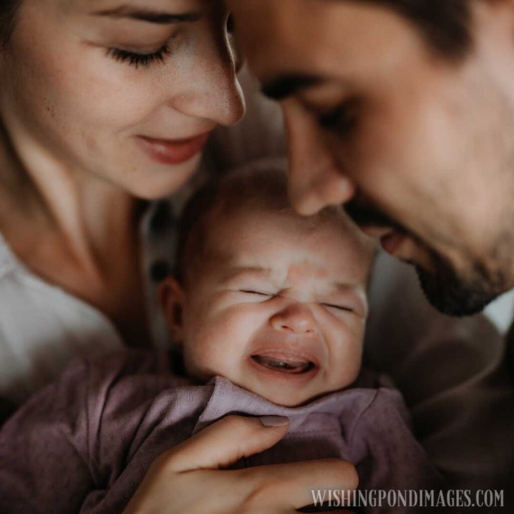 Close up of happy young parents holding and kissing their newborn baby. Newborn baby image