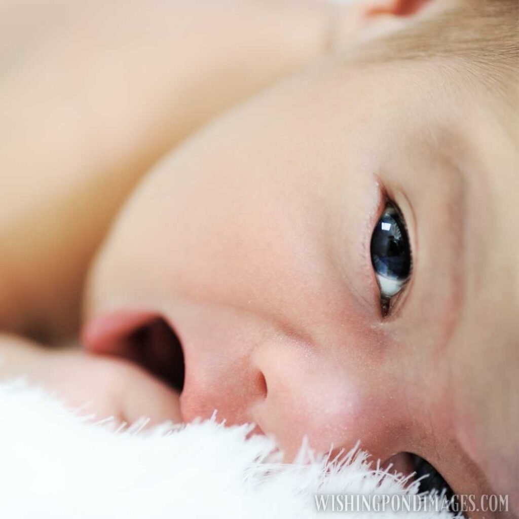Cute little newborn baby lying on bed at home. Newborn baby images