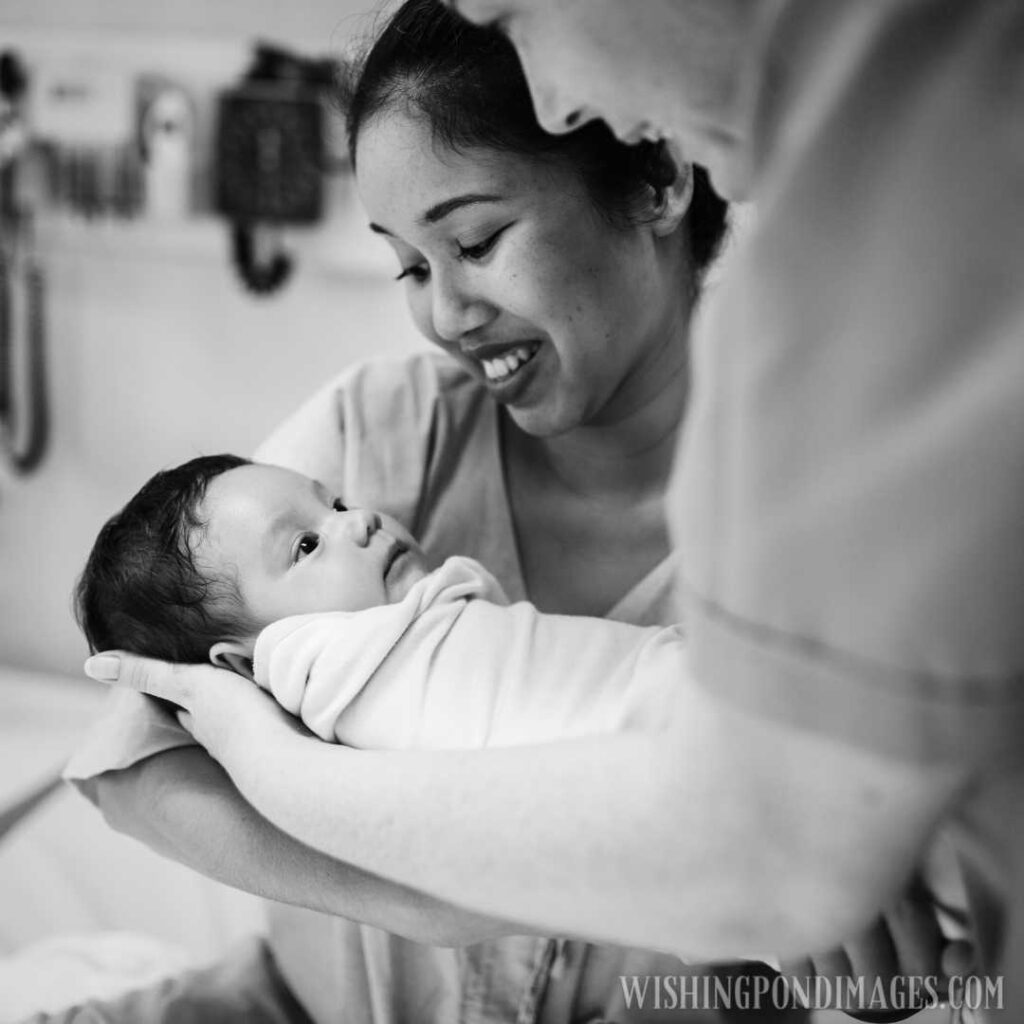 Father and mother holding newborn baby in her hands. Newborn baby image
