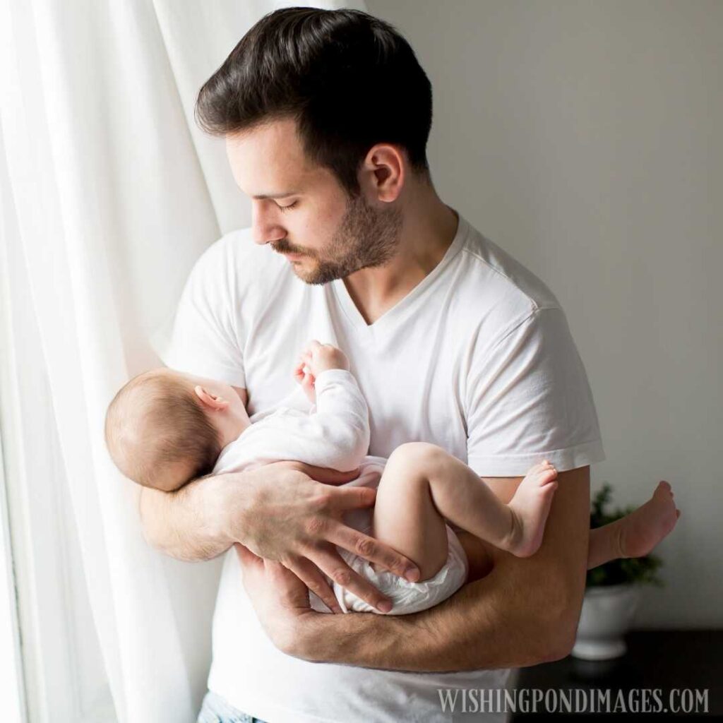 Father holding newborn baby in his both arms. Newborn baby image