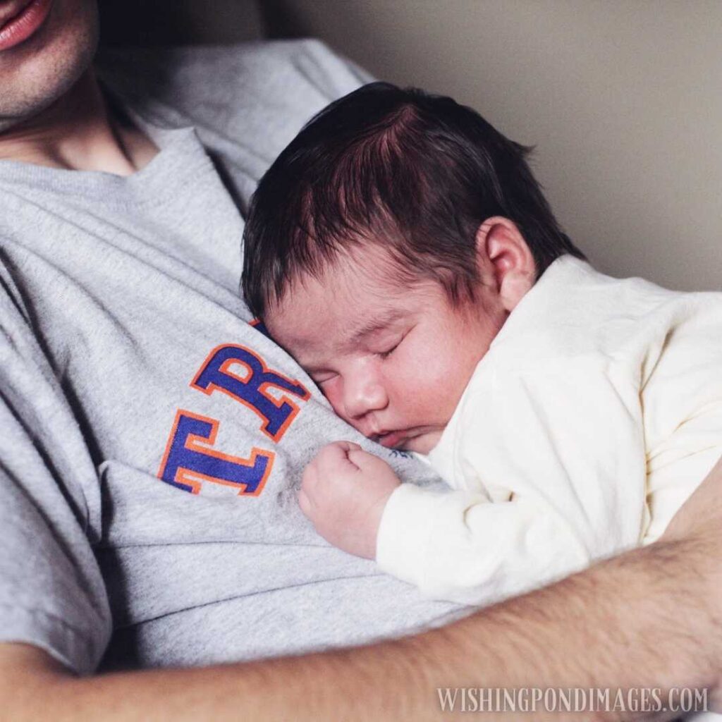 Newborn baby sleeping on father's lap. Newborn baby images