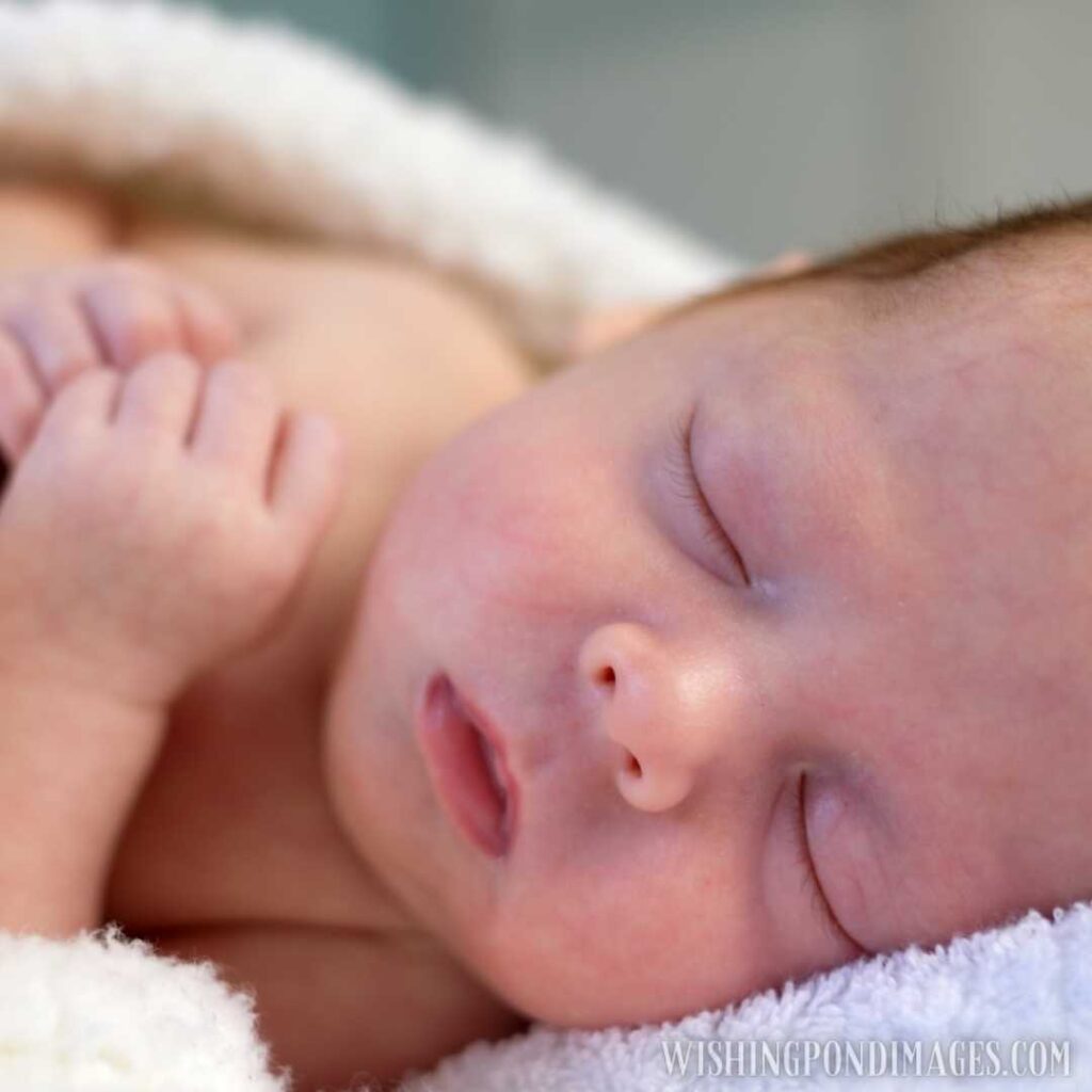Sleeping newborn baby under soft white carpet. Newborn baby images