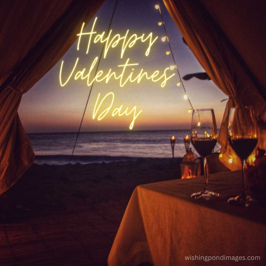 Two glass of vines on the table on the beach on valentines day