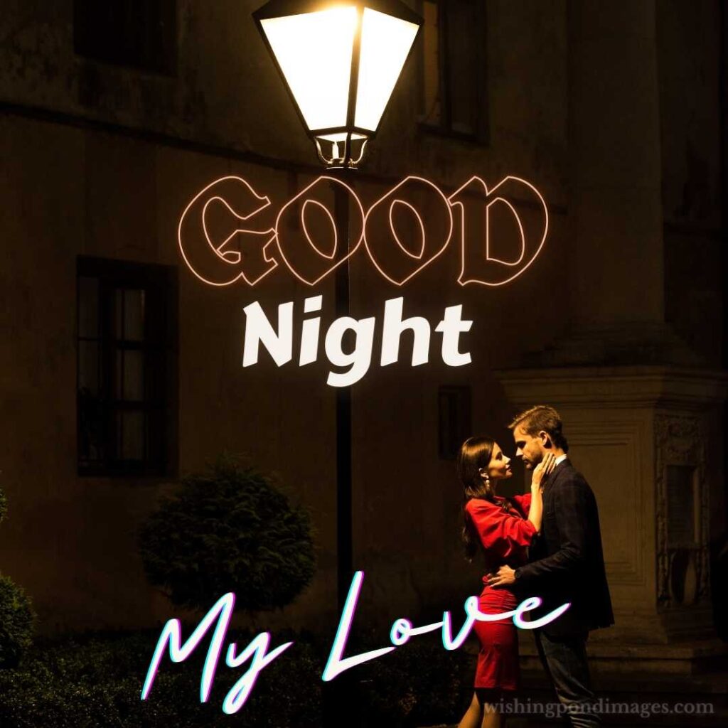 Young elegant couple hugging while standing under street lamp at night