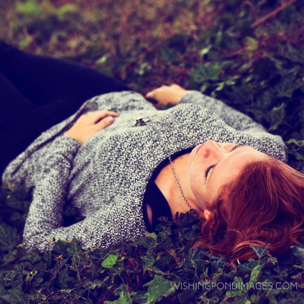 A beautiful red haired girl laying on the ground feeling so lonely. Feeling alone images girl.