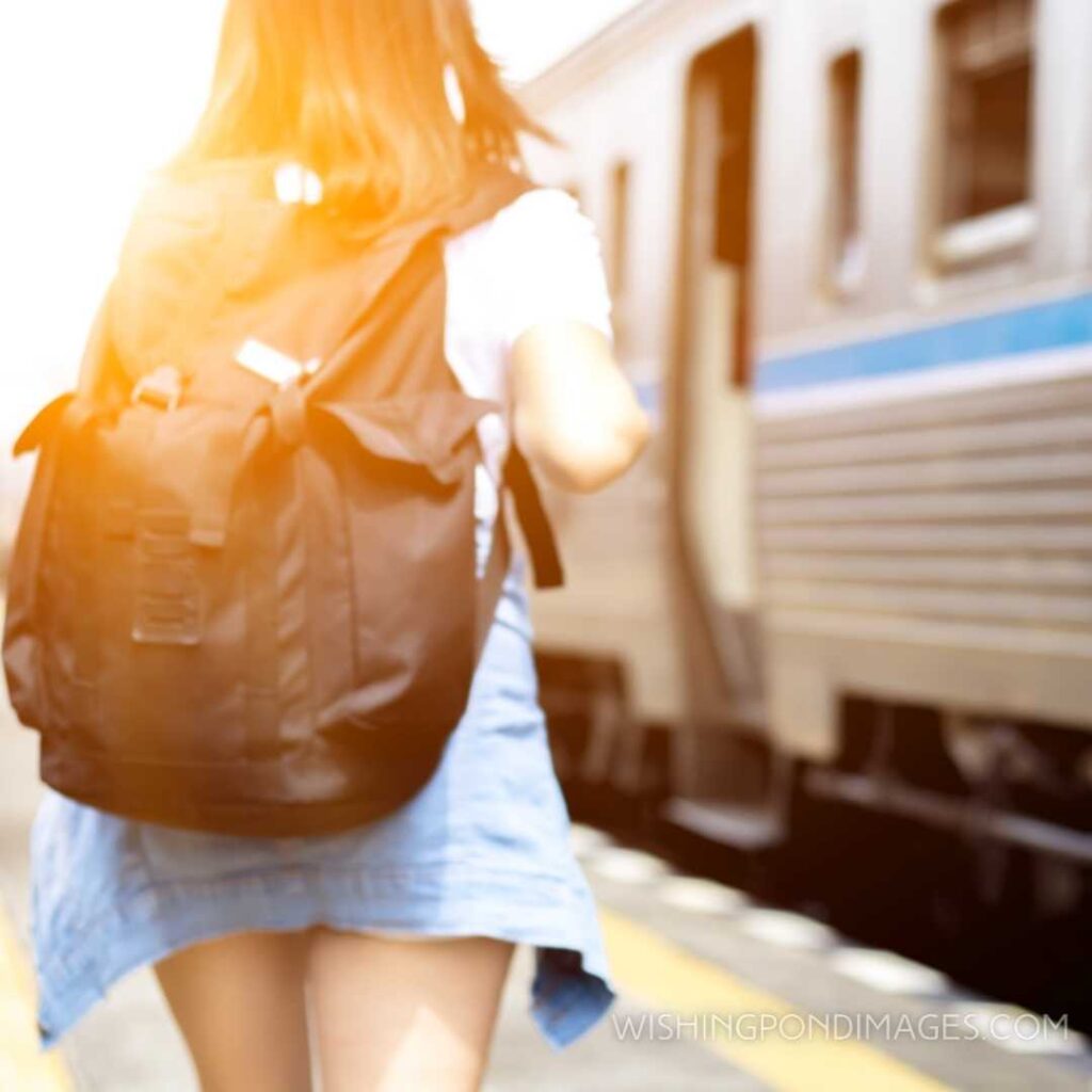 A girl wearing backpack walking alone along the train. Feeling alone images girl.