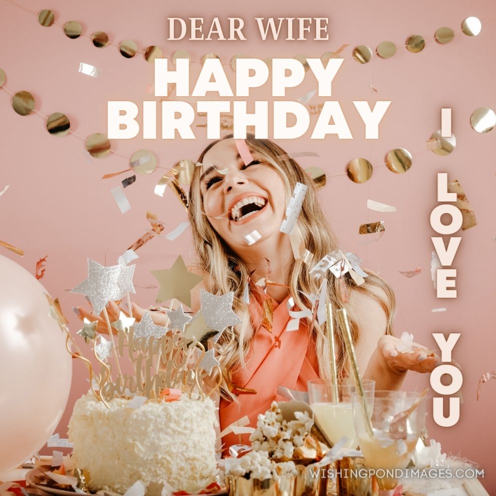An images of lady celebrating birthday party with decorations and white-colored cake on the table. Happy birthday wife images.