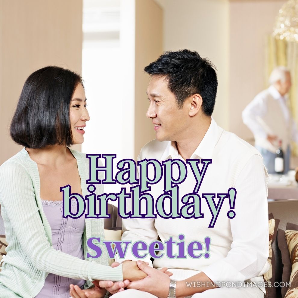 Asian couple sitting on couch and looking at each other. Happy birthday wife images.