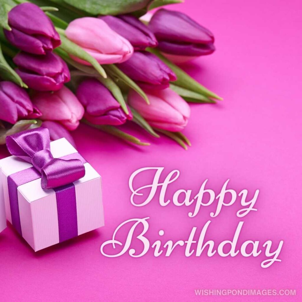 Box with a gif, bouquet of beautiful flowers, buds of spring tulips flowers on pink background. Happy birthday tulips flowers images