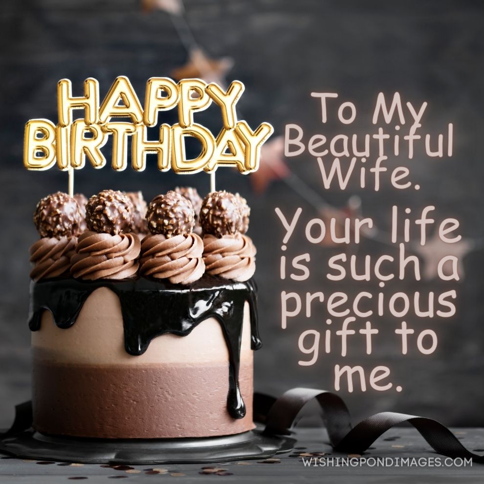 Chocolate birthday cake with chocolate ganache drip icing and happy birthday banner. Happy birthday wife images.