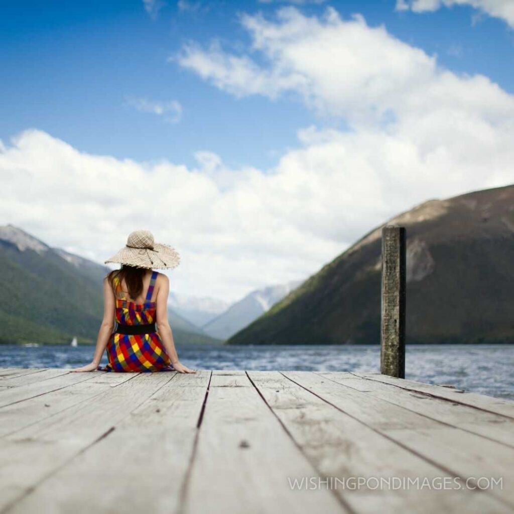 Girl sitting alone near the lake. Feeling alone images girl.