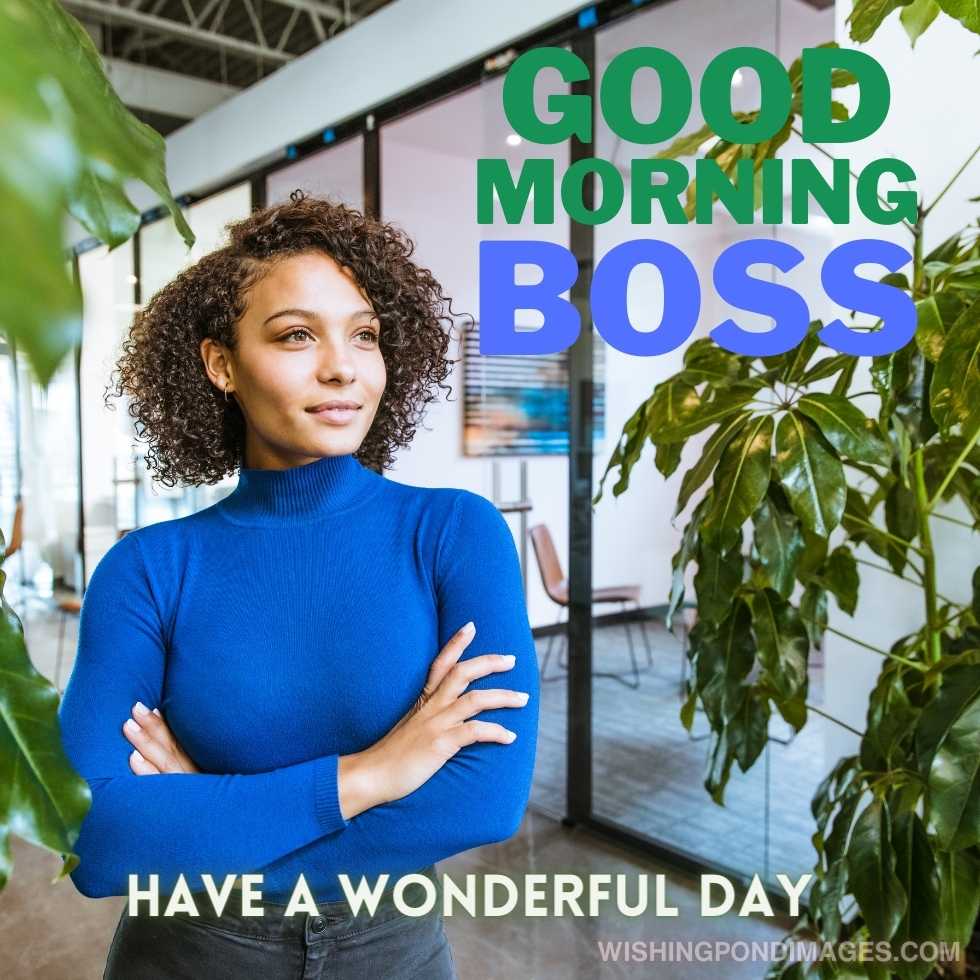 Good looking biracial young woman standing in an office, surrounded by large green plants. Good morning boss Images