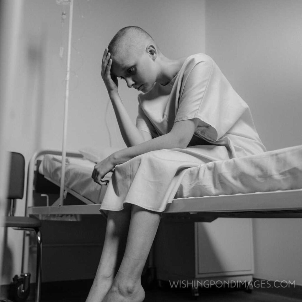 Grayscale picture of a hairless girl sitting in the hospital ward. Feeling alone images girl.