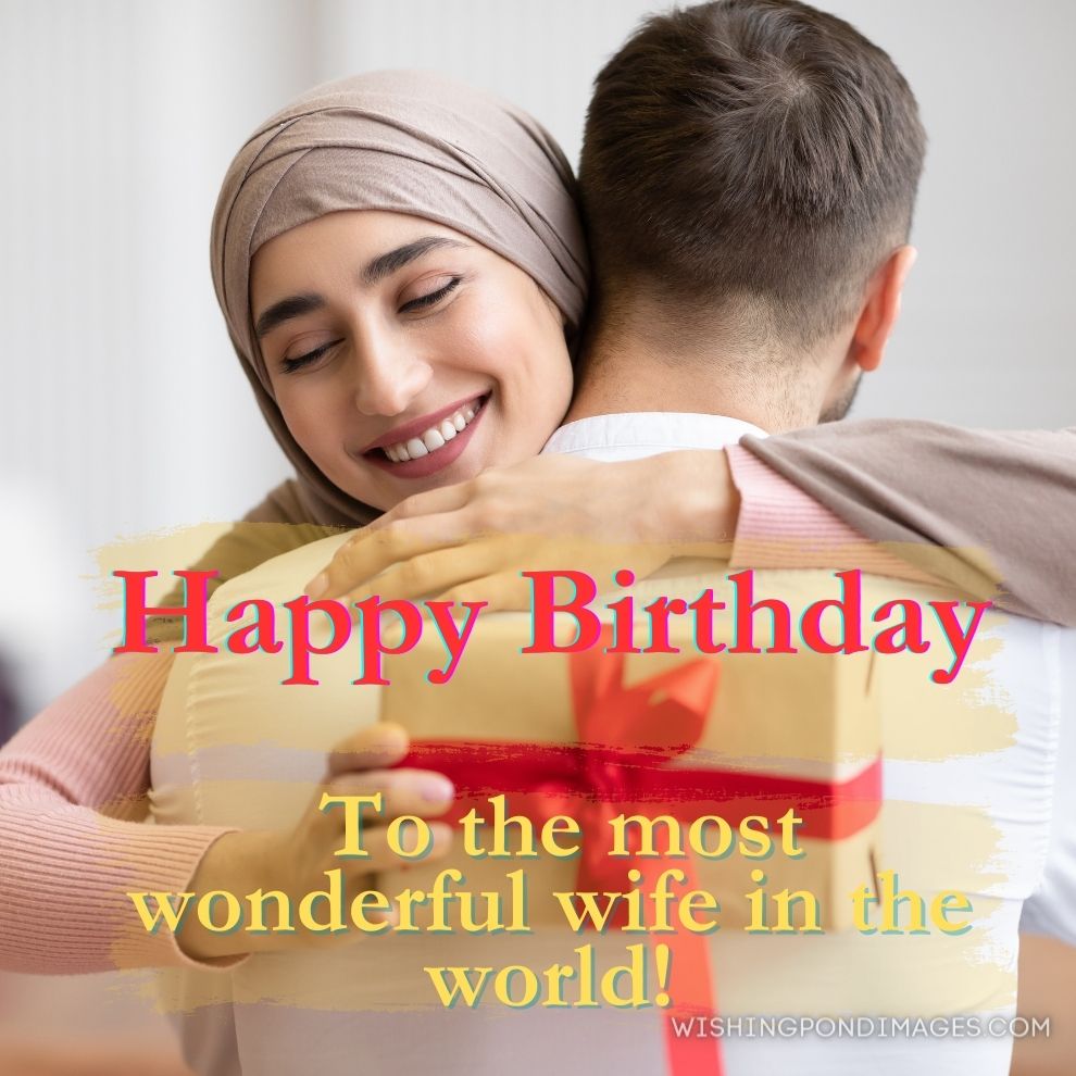 Happy muslim wife higging husband receiving wrapped gift at home. Happy birthday wife images