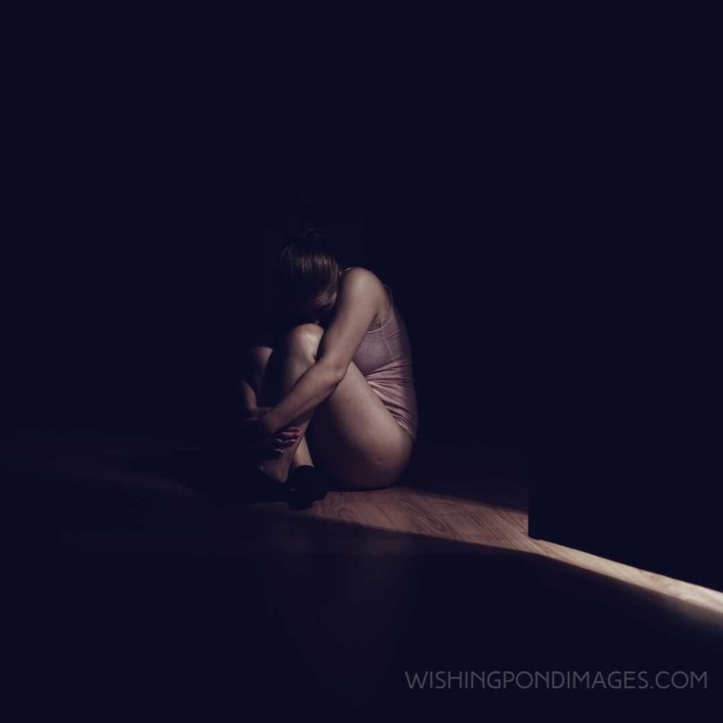 Lonely and dark feelings of a scared woman in the room feeling terrified. Feeling alone images girl.