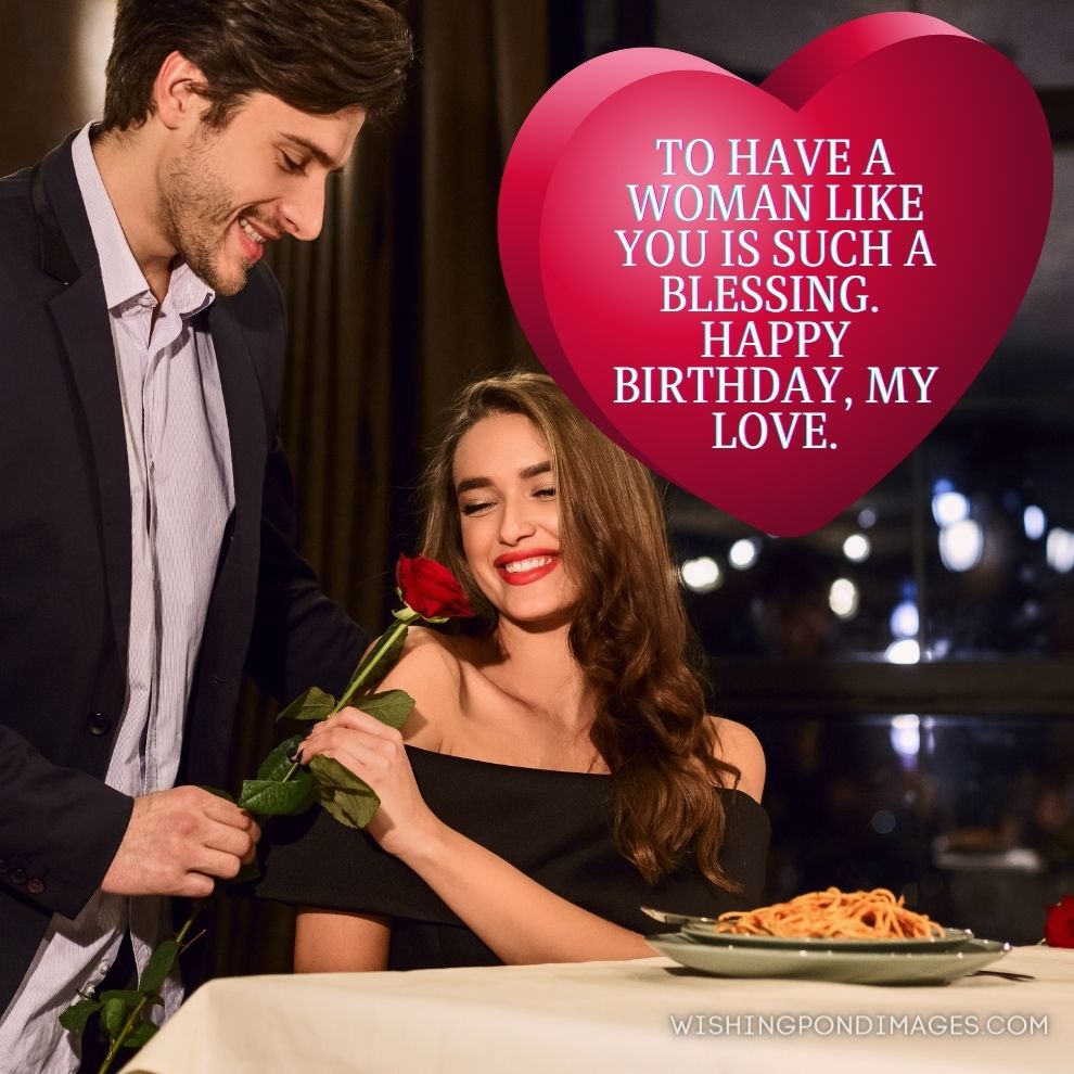 Man giving rose to his happy girlfriend during a romantic dinner in the restaurant. Happy Birthday wife images.
