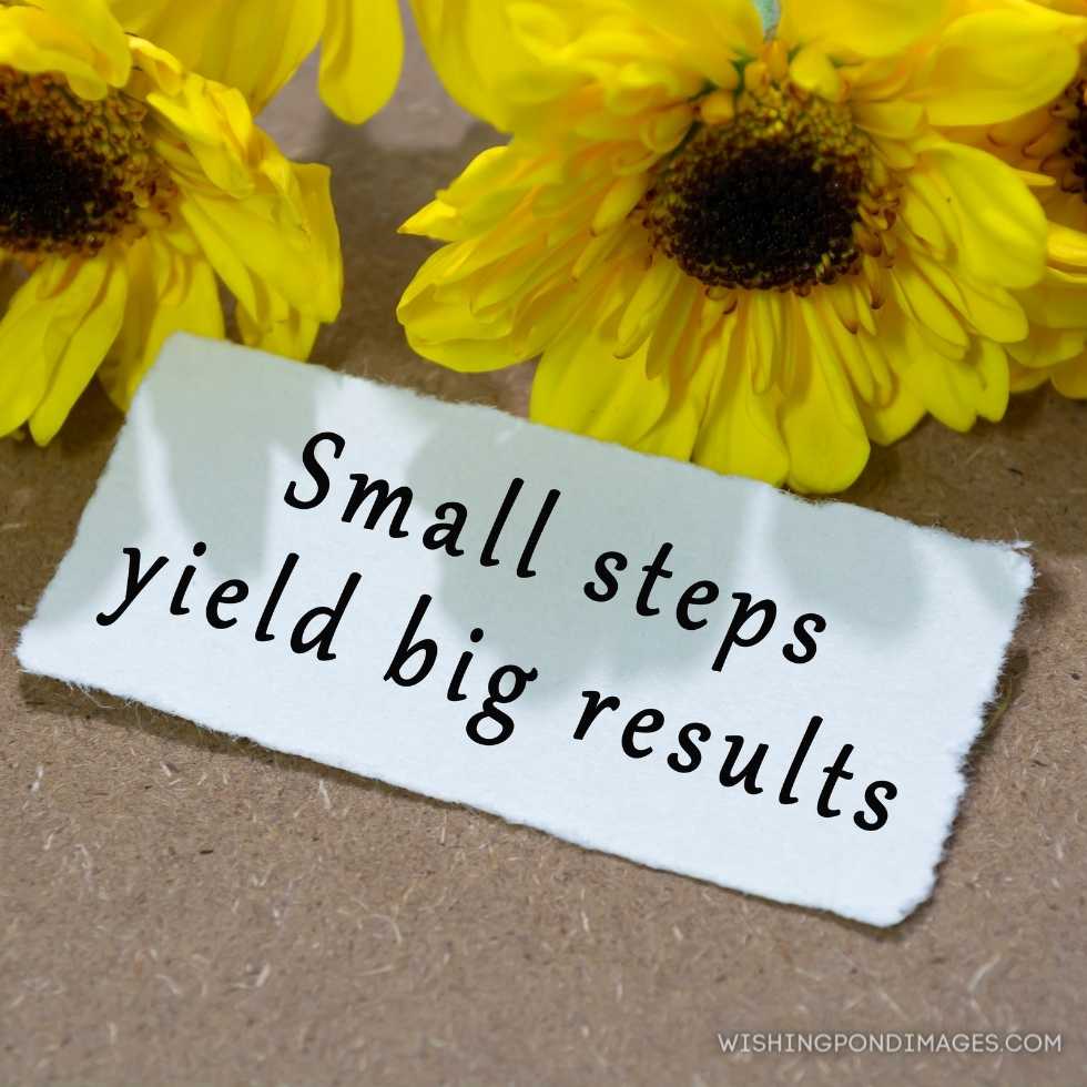 Motivational quote on torn white paper with sunflower on wooden table background - Small steps yield big results. Inspirational quotes images