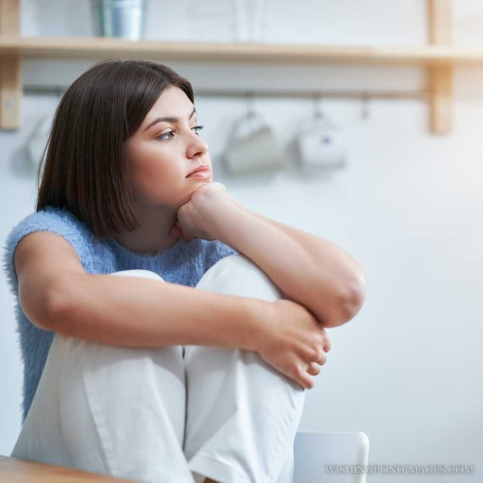 Picture a sad teenage girl sitting alone at home. Sad girl in room.