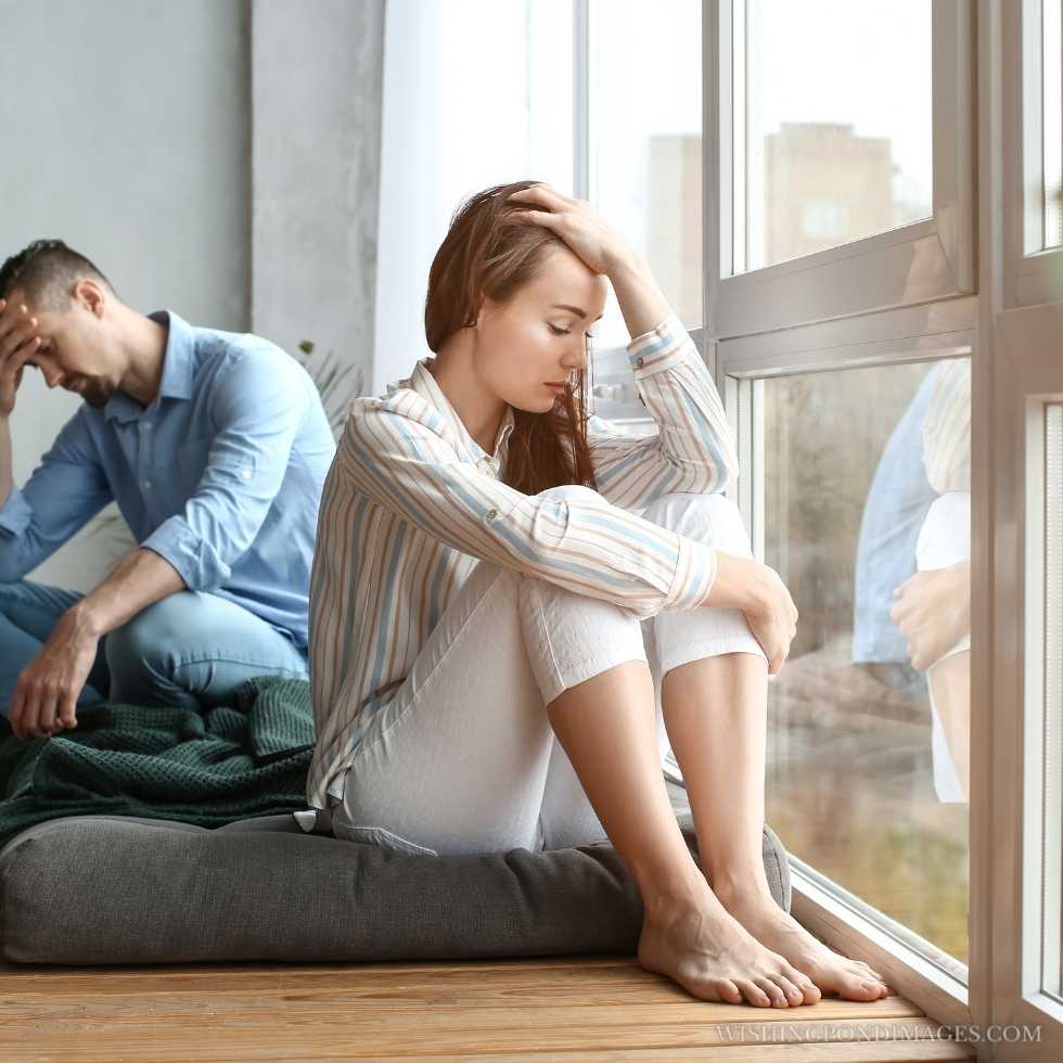 Sad couple after a quarrel at home. Sad girl in room.