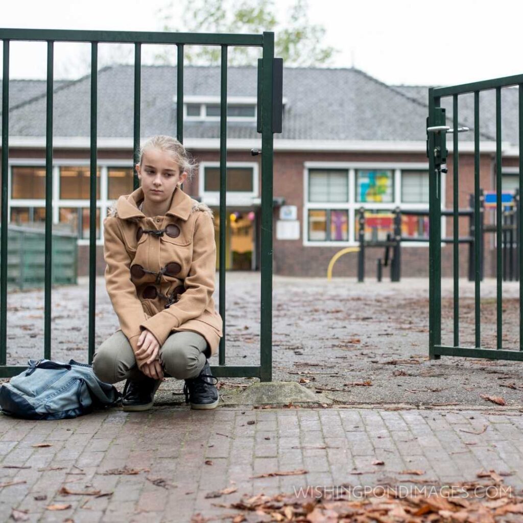 Schoolgirl at school outside sad and alone. Feeling alone images girl