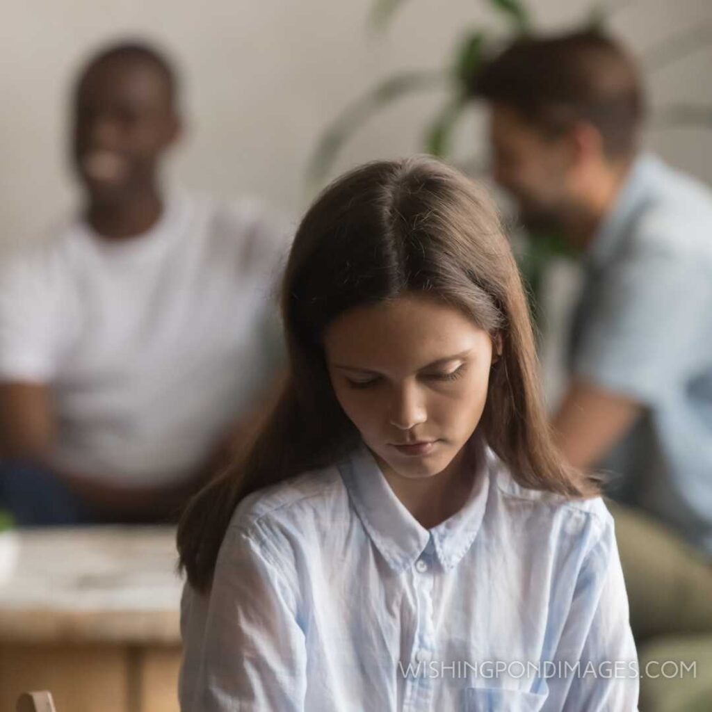 Upset bullied young girl sitting alone excluded by bad friends. Feeling alone images girl.