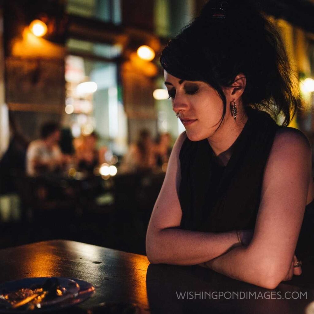 Woman sitting alone at the bar. Feeling alone images girl