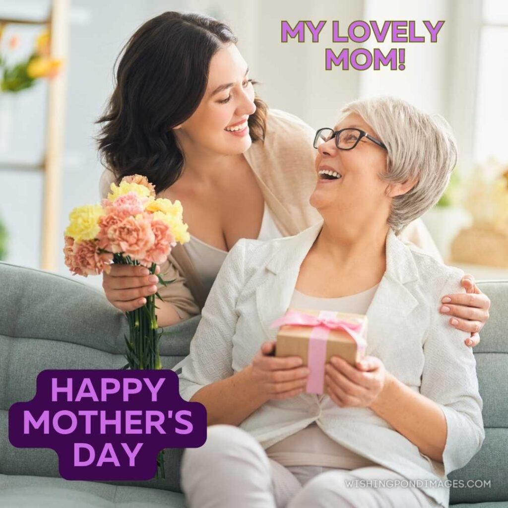 A beautiful woman and her mother with flowers and gift box at home. Happy Mothers Day images