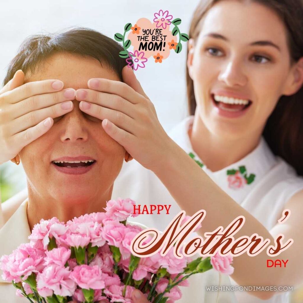 Daughter covering her mother's eyes with her both and smiling on mother's day. Happy Mothers Day images