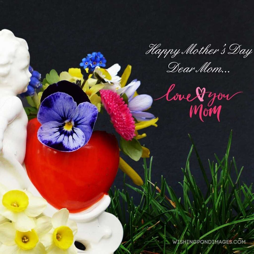 Happy mother's day dear mom written on dark background with little flowers. Happy Mothers Day images