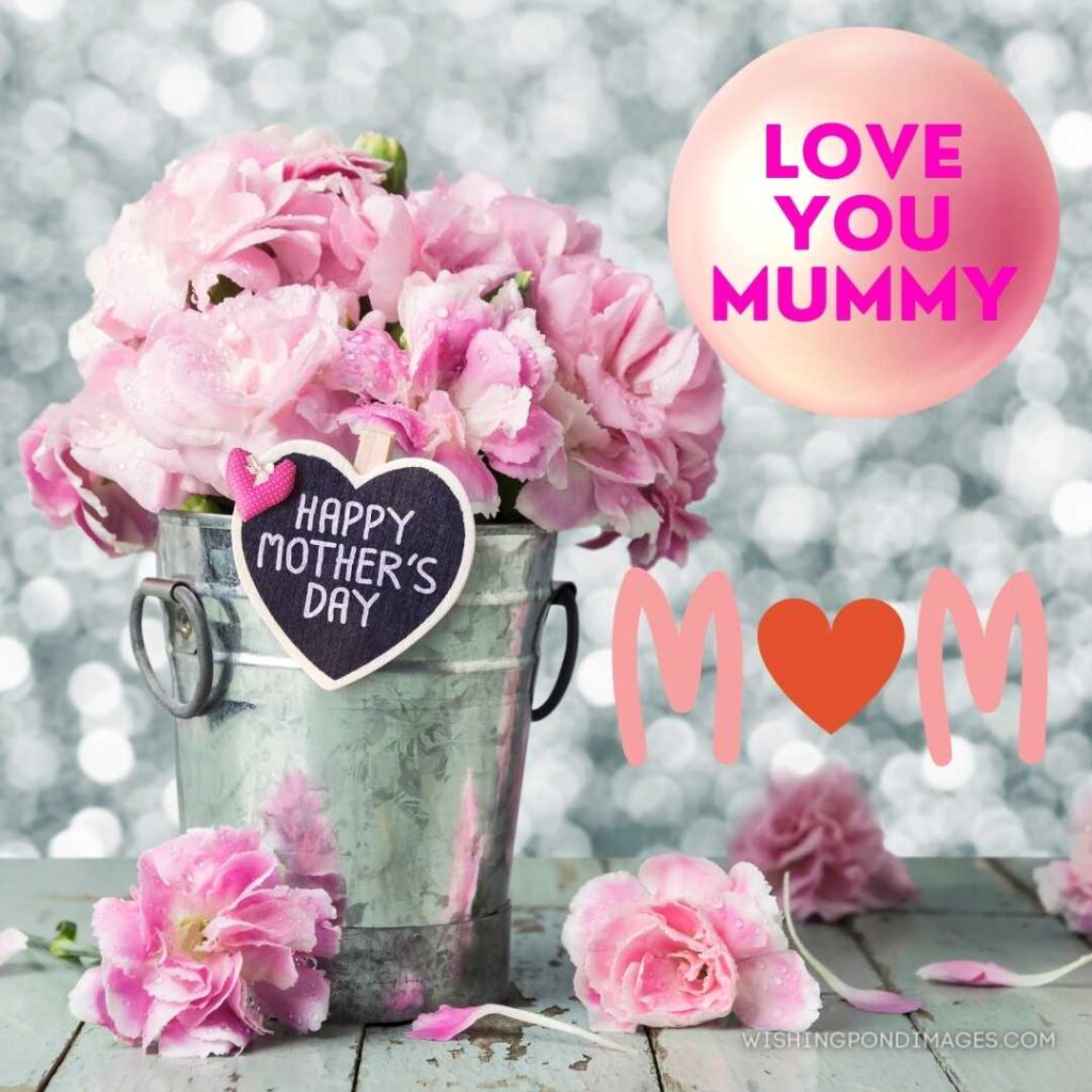 Happy mothers day letter on wood heart and pink carnation flowers in zinc bucket. Happy Mothers Day images