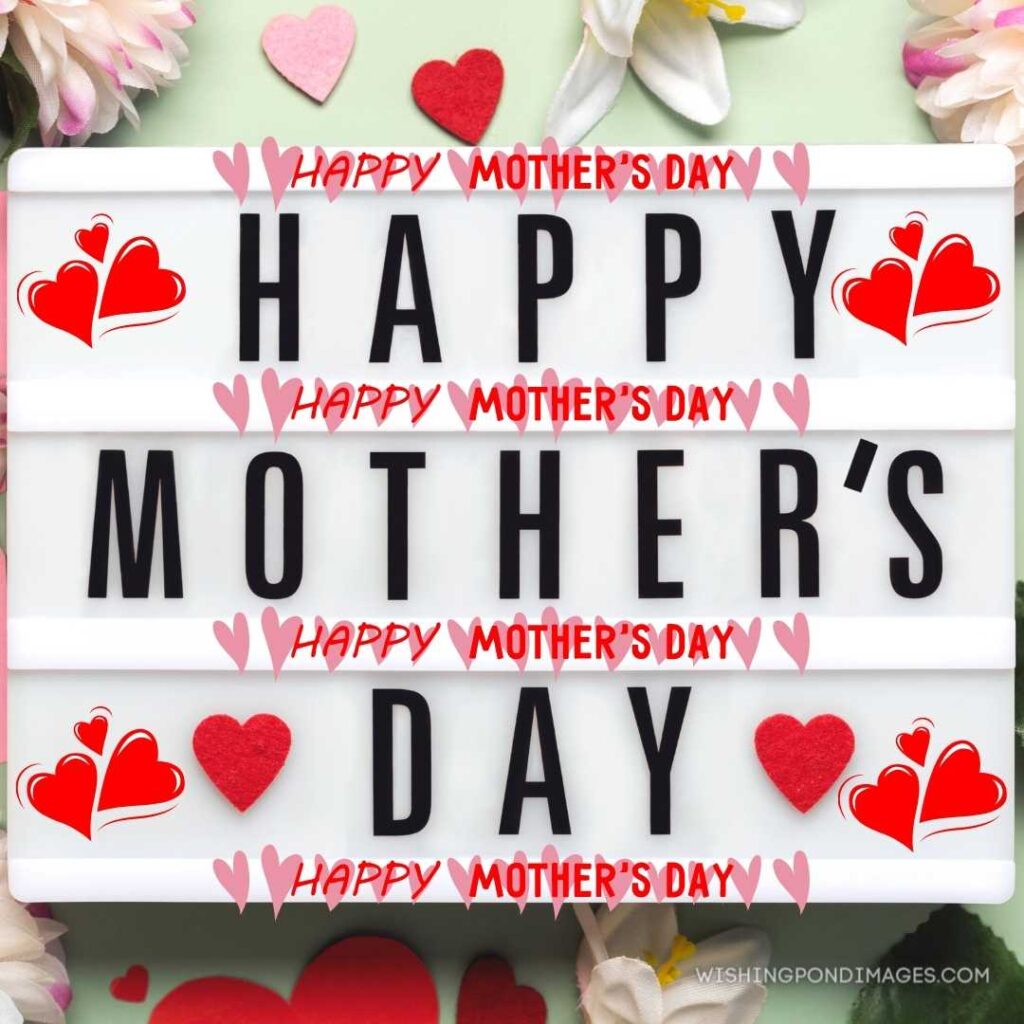 Light box with the happy mother's day next to hearts and flowers on a green background. Happy Mothers Day images