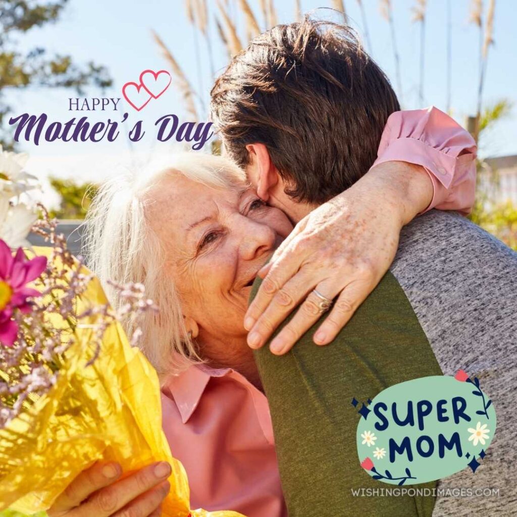 Mother hugs her son and thanks for the flowers on Mother's day. Happy Mothers Day images