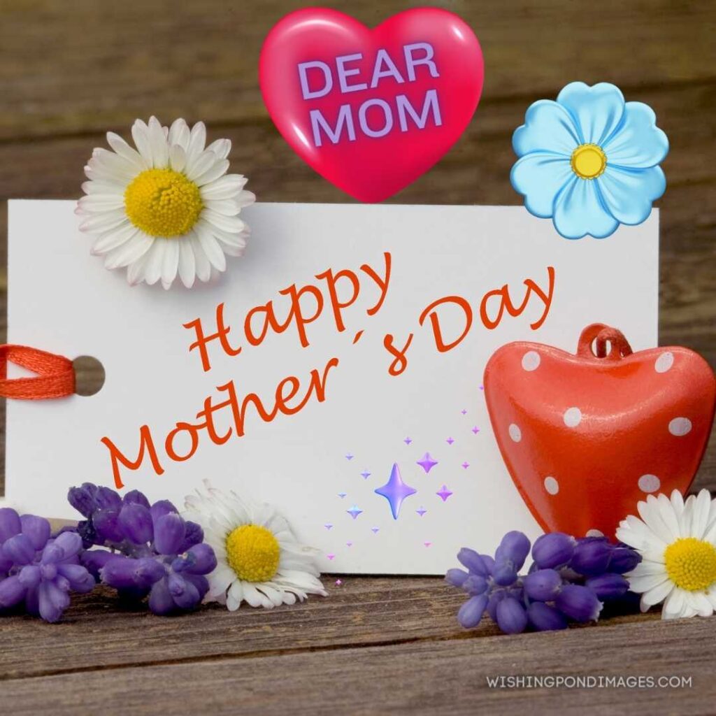 Mother's Day card on wooden background with flowers and red heart. Happy Mothers Day images