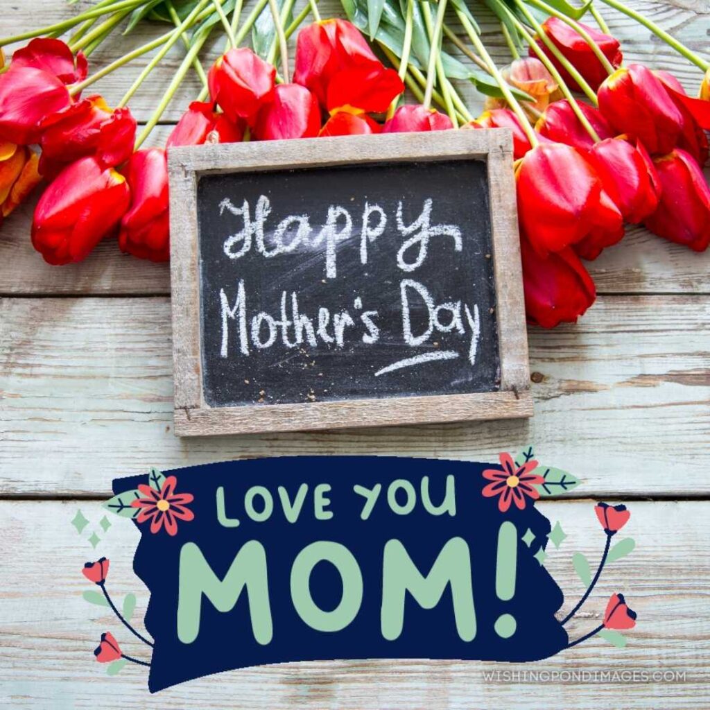 Red tulips on a wooden background with little chalkboard happy mother's day written on it. Happy Mothers Day images